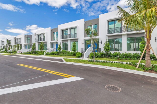 1921 Dock St, West Palm Beach, FL 33401 - view of building exterior with a residential view and uncovered parking