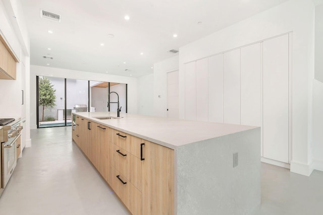 1921 Dock St, West Palm Beach, FL 33401 - kitchen with modern cabinets, light brown cabinets, finished concrete floors, a large island, and high end stainless steel range