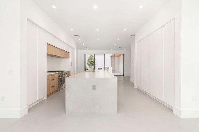 1921 Dock St, West Palm Beach, FL 33401 - kitchen featuring high end range, modern cabinets, finished concrete floors, recessed lighting, and an island with sink