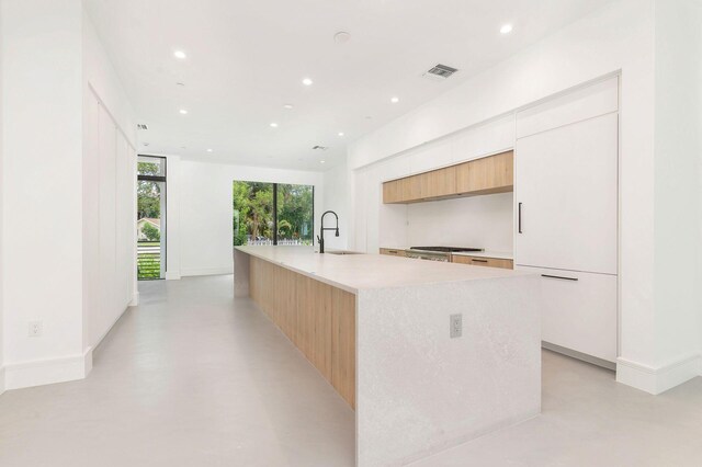 1921 Dock St, West Palm Beach, FL 33401 - kitchen with modern cabinets, recessed lighting, light countertops, concrete flooring, and a large island with sink