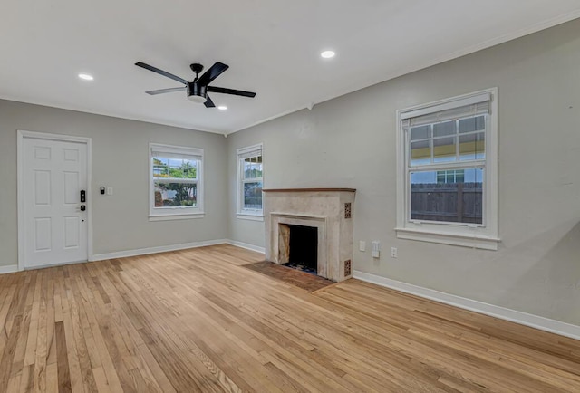 720 N Ocean Breeze, Lake Worth Beach, FL 33460 - unfurnished living room with light wood finished floors, a high end fireplace, a ceiling fan, recessed lighting, and ornamental molding