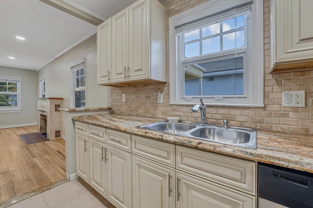 720 N Ocean Breeze, Lake Worth Beach, FL 33460 - kitchen featuring dishwashing machine, backsplash, plenty of natural light, crown molding, and light tile patterned floors