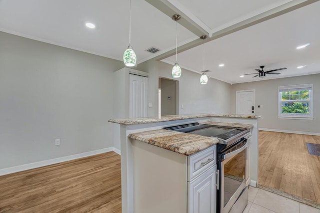 720 N Ocean Breeze, Lake Worth Beach, FL 33460 - kitchen featuring stainless steel range with electric stovetop, light wood finished floors, pendant lighting, crown molding, and light stone countertops