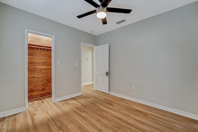 720 N Ocean Breeze, Lake Worth Beach, FL 33460 - unfurnished bedroom with light wood-style flooring, a spacious closet, ceiling fan, and a closet