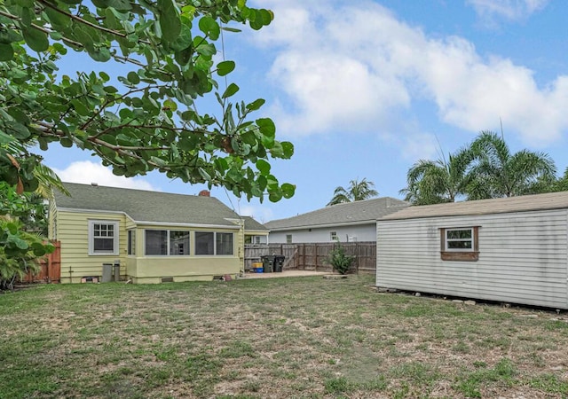 720 N Ocean Breeze, Lake Worth Beach, FL 33460 - fenced backyard featuring an outbuilding and a sunroom