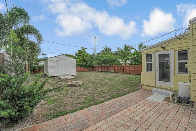 720 N Ocean Breeze, Lake Worth Beach, FL 33460 - fenced backyard featuring a patio, an outdoor fire pit, a storage shed, and entry steps