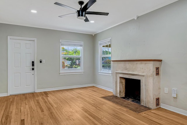 720 N Ocean Breeze, Lake Worth Beach, FL 33460 - unfurnished living room featuring light wood-style floors, crown molding, a premium fireplace, ceiling fan, and recessed lighting