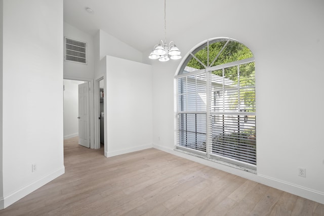 1633 SE Clearmont St, Port Saint Lucie, FL 34983 - unfurnished dining area with a chandelier, light wood finished floors, and high vaulted ceiling