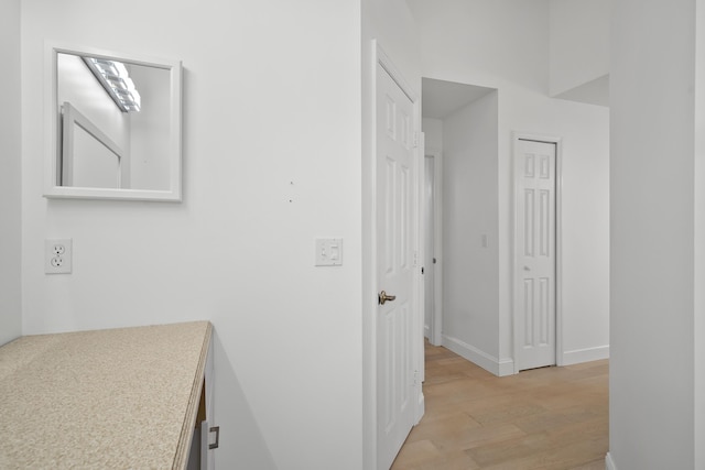 1633 SE Clearmont St, Port Saint Lucie, FL 34983 - hallway with light wood-style floors and baseboards