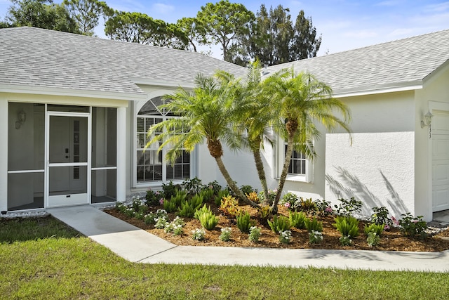 1633 SE Clearmont St, Port Saint Lucie, FL 34983 - doorway to property featuring stucco siding, roof with shingles, and an attached garage