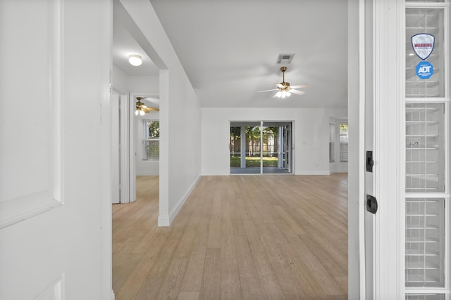 1633 SE Clearmont St, Port Saint Lucie, FL 34983 - corridor featuring light wood finished floors and plenty of natural light