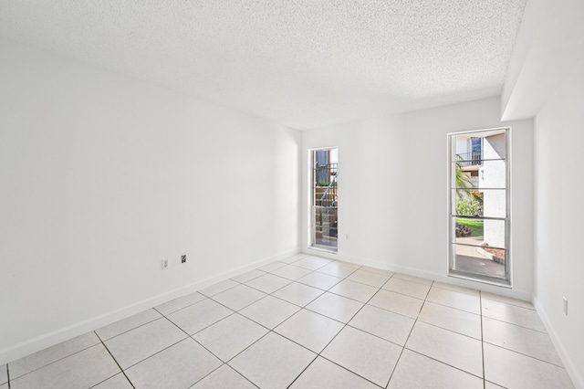 7 Greenway N Unit 111, Royal Palm Beach, FL 33411 - spare room with plenty of natural light, a textured ceiling, and light tile patterned floors
