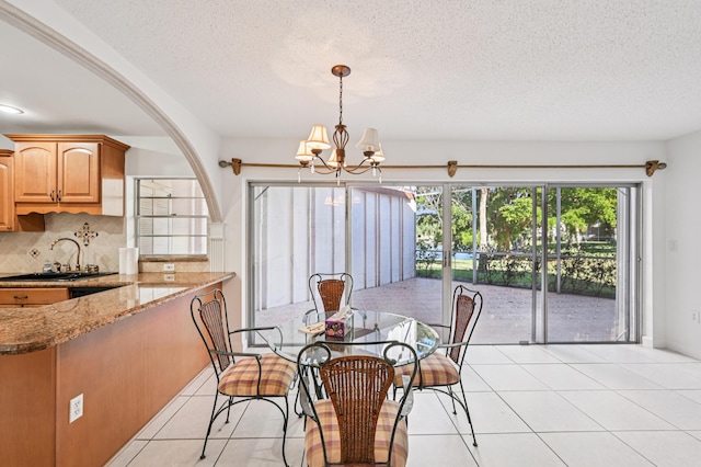 7 Greenway N Unit 111, Royal Palm Beach, FL 33411 - dining room featuring a chandelier, light tile patterned floors, and a textured ceiling