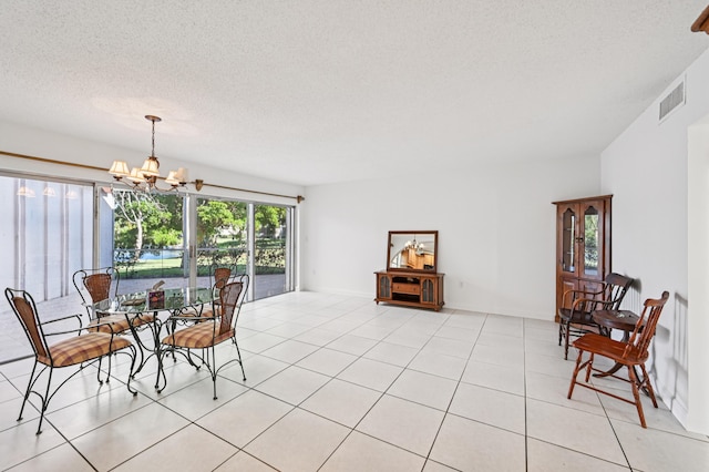 7 Greenway N Unit 111, Royal Palm Beach, FL 33411 - dining space featuring a chandelier, light tile patterned flooring, and a textured ceiling
