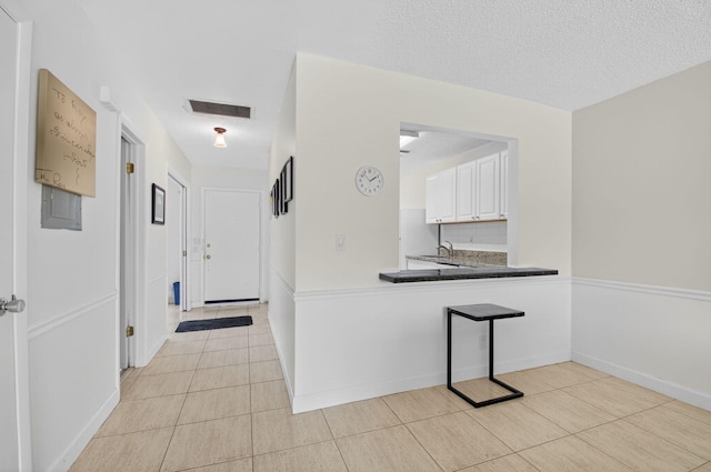 13984 Via Flora Unit B, Delray Beach, FL 33484 - corridor featuring light tile patterned floors and a textured ceiling