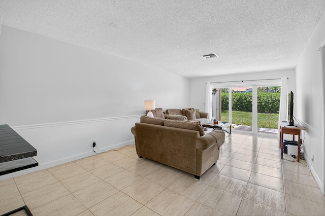 13984 Via Flora Unit B, Delray Beach, FL 33484 - living room featuring a textured ceiling and light tile patterned floors