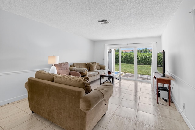 13984 Via Flora Unit B, Delray Beach, FL 33484 - living room featuring a textured ceiling and light tile patterned flooring
