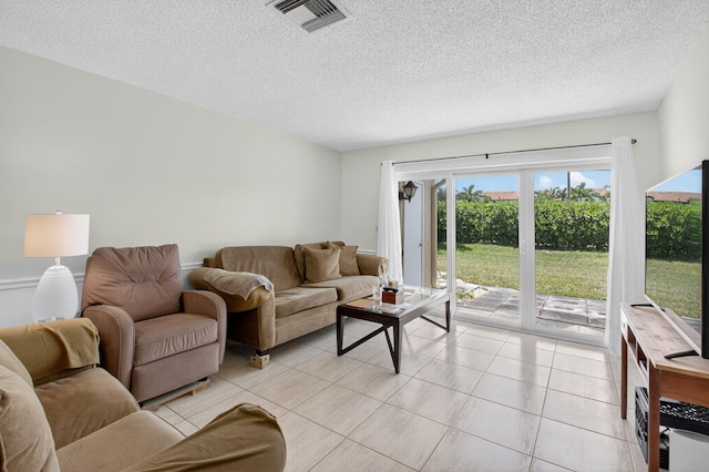 13984 Via Flora Unit B, Delray Beach, FL 33484 - living room featuring a textured ceiling and light tile patterned floors