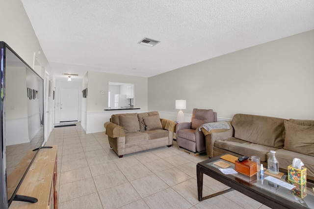 13984 Via Flora Unit B, Delray Beach, FL 33484 - living room with a textured ceiling and light tile patterned floors