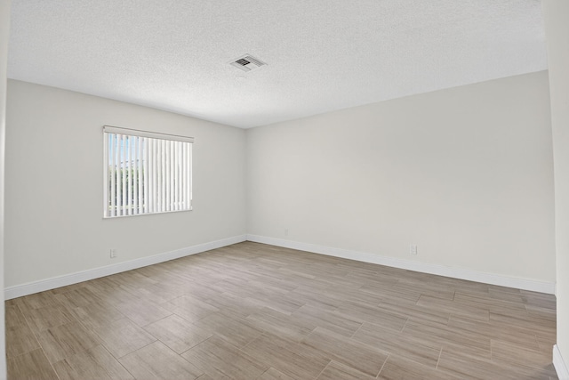 13984 Via Flora Unit B, Delray Beach, FL 33484 - unfurnished room featuring a textured ceiling and light wood-type flooring