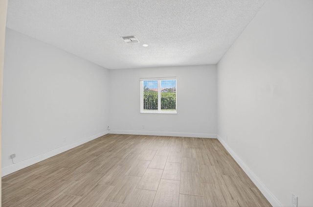 13984 Via Flora Unit B, Delray Beach, FL 33484 - spare room featuring light wood-type flooring and a textured ceiling