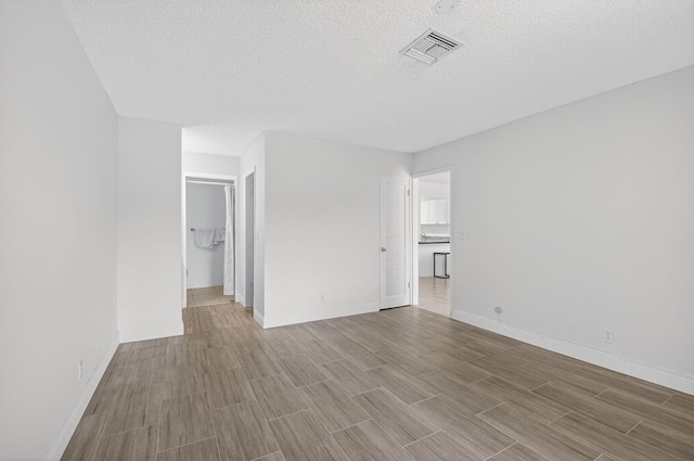 13984 Via Flora Unit B, Delray Beach, FL 33484 - empty room featuring wood finished floors and a textured ceiling
