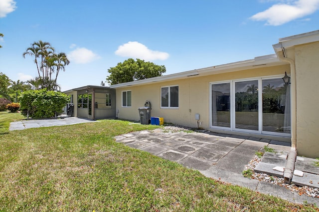 13984 Via Flora Unit B, Delray Beach, FL 33484 - rear view of property with a patio area, stucco siding, and a lawn