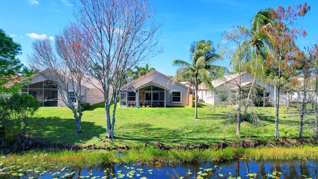 1738 Barnstable Rd, Wellington, FL 33414 - back of house featuring a water view, a yard, and stucco siding