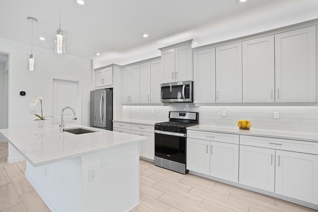 11687 SW Viridian Blvd, Port Saint Lucie, FL 34987 - kitchen with appliances with stainless steel finishes, recessed lighting, decorative backsplash, light countertops, and a kitchen island with sink