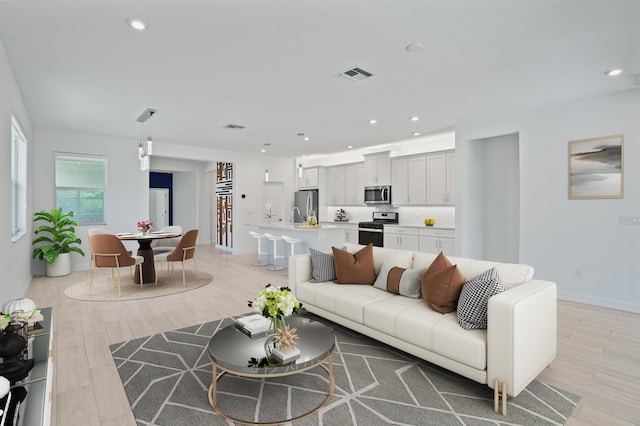 11687 SW Viridian Blvd, Port Saint Lucie, FL 34987 - living room with light wood finished floors and recessed lighting