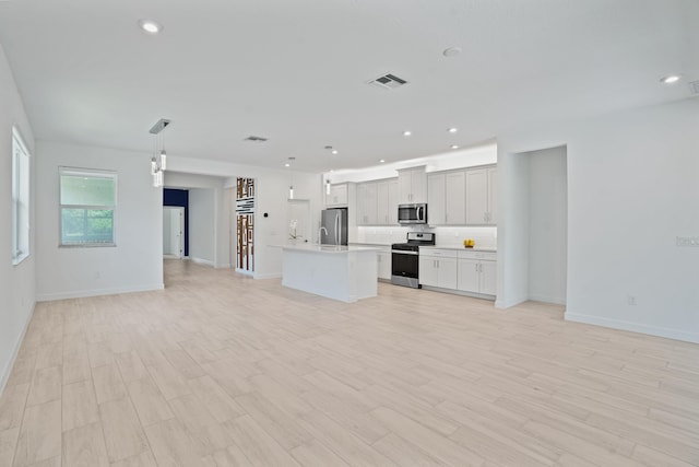 11687 SW Viridian Blvd, Port Saint Lucie, FL 34987 - unfurnished living room featuring light wood-type flooring and recessed lighting