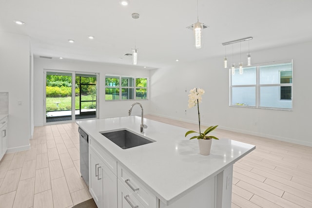 11687 SW Viridian Blvd, Port Saint Lucie, FL 34987 - kitchen with stainless steel dishwasher, recessed lighting, light countertops, pendant lighting, and light wood-type flooring