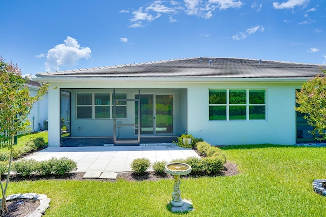 11687 SW Viridian Blvd, Port Saint Lucie, FL 34987 - rear view of property featuring stucco siding, a lawn, and a patio area