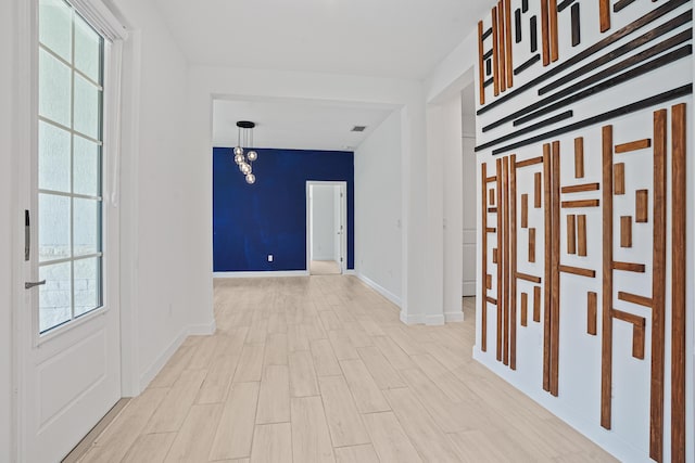 11687 SW Viridian Blvd, Port Saint Lucie, FL 34987 - corridor featuring healthy amount of natural light and light wood-style flooring