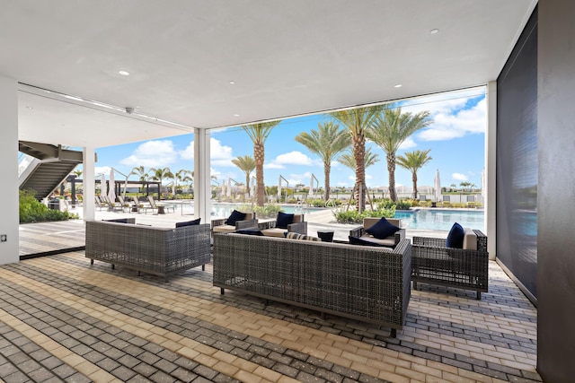 11687 SW Viridian Blvd, Port Saint Lucie, FL 34987 - view of patio / terrace featuring an outdoor living space and a community pool
