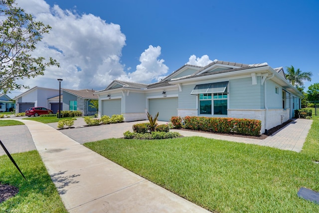 11687 SW Viridian Blvd, Port Saint Lucie, FL 34987 - view of front of house with a front lawn, an attached garage, driveway, and a tile roof