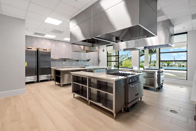 11687 SW Viridian Blvd, Port Saint Lucie, FL 34987 - kitchen with open shelves, a kitchen island, designer stove, light countertops, and a paneled ceiling