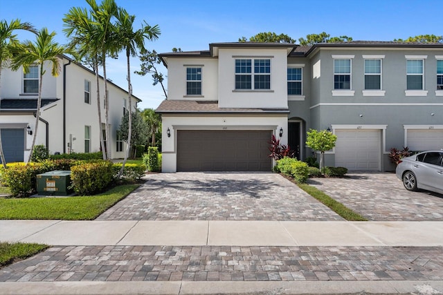6161 Rancho Ln, West Palm Beach, FL 33415 - view of property featuring an attached garage, stucco siding, and driveway