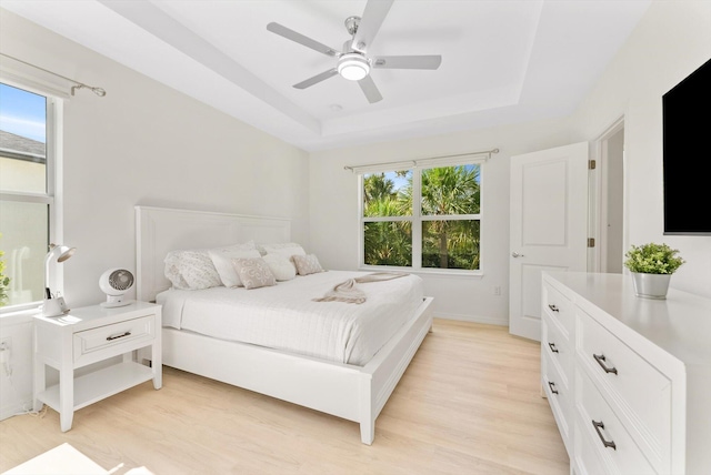 6161 Rancho Ln, West Palm Beach, FL 33415 - bedroom with light wood-type flooring, a tray ceiling, and ceiling fan