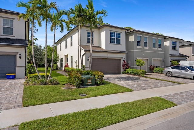 6161 Rancho Ln, West Palm Beach, FL 33415 - multi unit property with stucco siding, driveway, a garage, and a front lawn