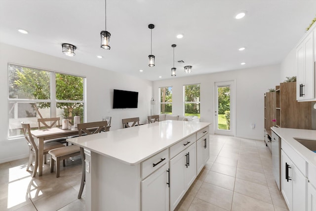6161 Rancho Ln, West Palm Beach, FL 33415 - kitchen with decorative light fixtures, recessed lighting, light countertops, a kitchen island, and white cabinets