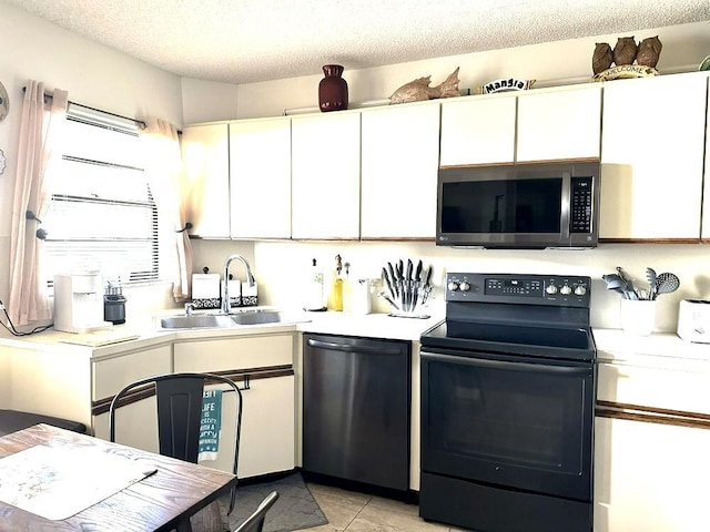 5807 Parkwalk Dr Unit 1124, Boynton Beach, FL 33472 - kitchen featuring appliances with stainless steel finishes, light countertops, white cabinetry, a textured ceiling, and light tile patterned floors