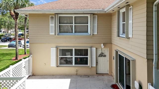 4604 Roxbury Ct, Boynton Beach, FL 33436 - view of side of home with a shingled roof and a patio