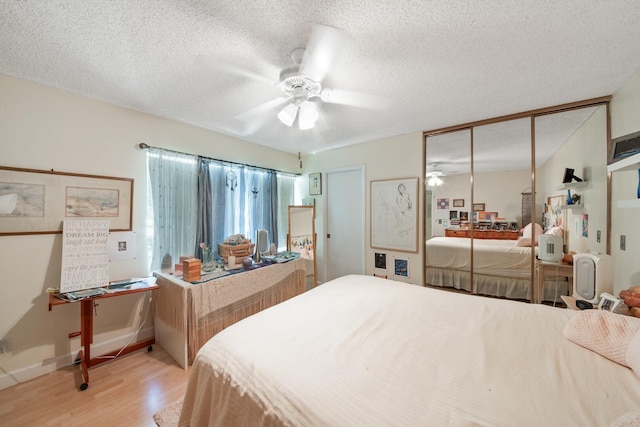 4604 Roxbury Ct, Boynton Beach, FL 33436 - bedroom featuring light wood finished floors, a textured ceiling, and a ceiling fan