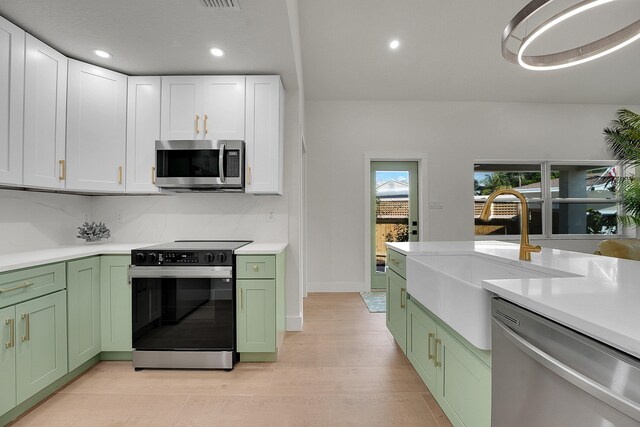 950 York St, West Palm Beach, FL 33401 - kitchen featuring green cabinetry, appliances with stainless steel finishes, light countertops, and recessed lighting