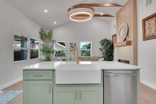 950 York St, West Palm Beach, FL 33401 - kitchen with dishwasher, green cabinetry, lofted ceiling, light countertops, and light wood finished floors