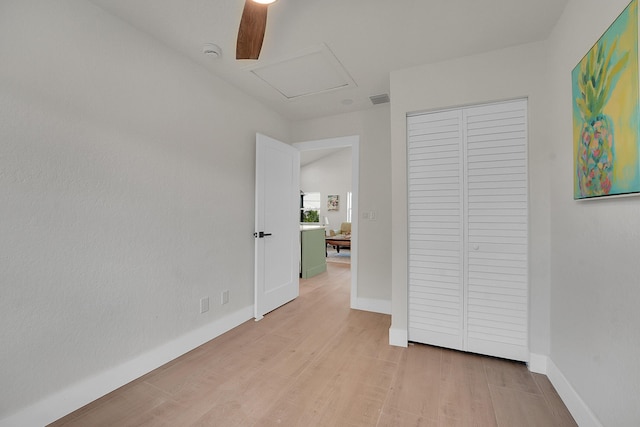 950 York St, West Palm Beach, FL 33401 - unfurnished bedroom with attic access, light wood-style flooring, a closet, and a ceiling fan