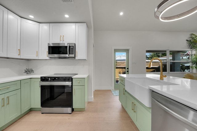 950 York St, West Palm Beach, FL 33401 - kitchen featuring green cabinetry, appliances with stainless steel finishes, light countertops, and recessed lighting