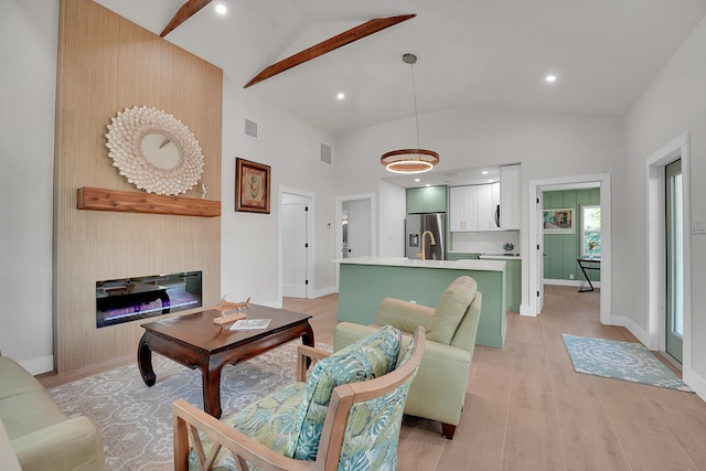 950 York St, West Palm Beach, FL 33401 - living room with light wood-type flooring, a glass covered fireplace, high vaulted ceiling, recessed lighting, and beam ceiling