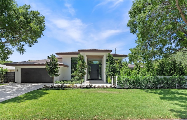 2265 NE 30th Ct, Lighthouse Point, FL 33064 - view of front of property featuring stucco siding, driveway, a tile roof, a front lawn, and an attached garage